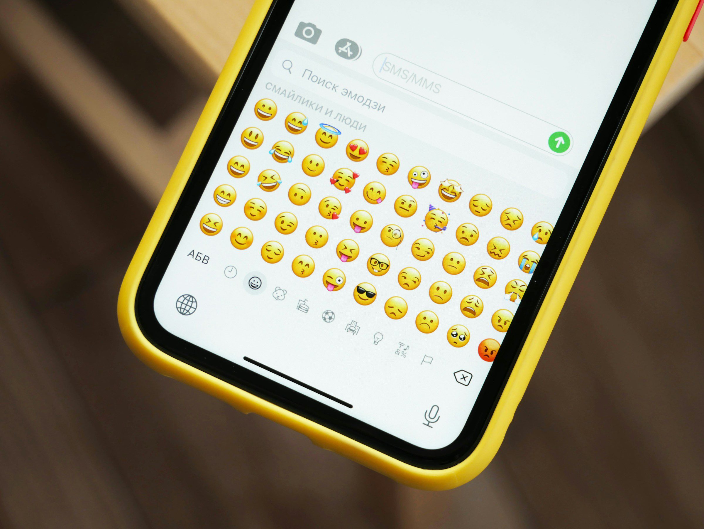 A cellphone with different emoji reactions